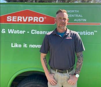 Blonde Male standing in front of SERVPRO of North Central Austin Truck with hands in pockets