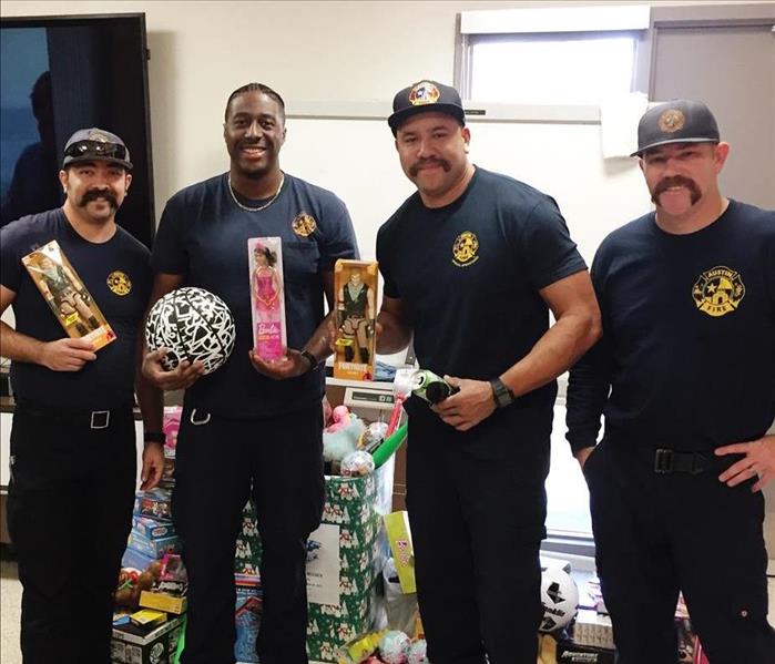 Firefighters holding toys