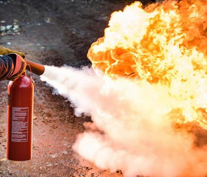 Fire extinguisher putting out flame