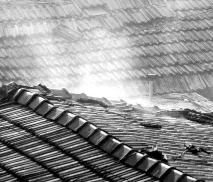 Hard rains tearing shingles off of a roof 