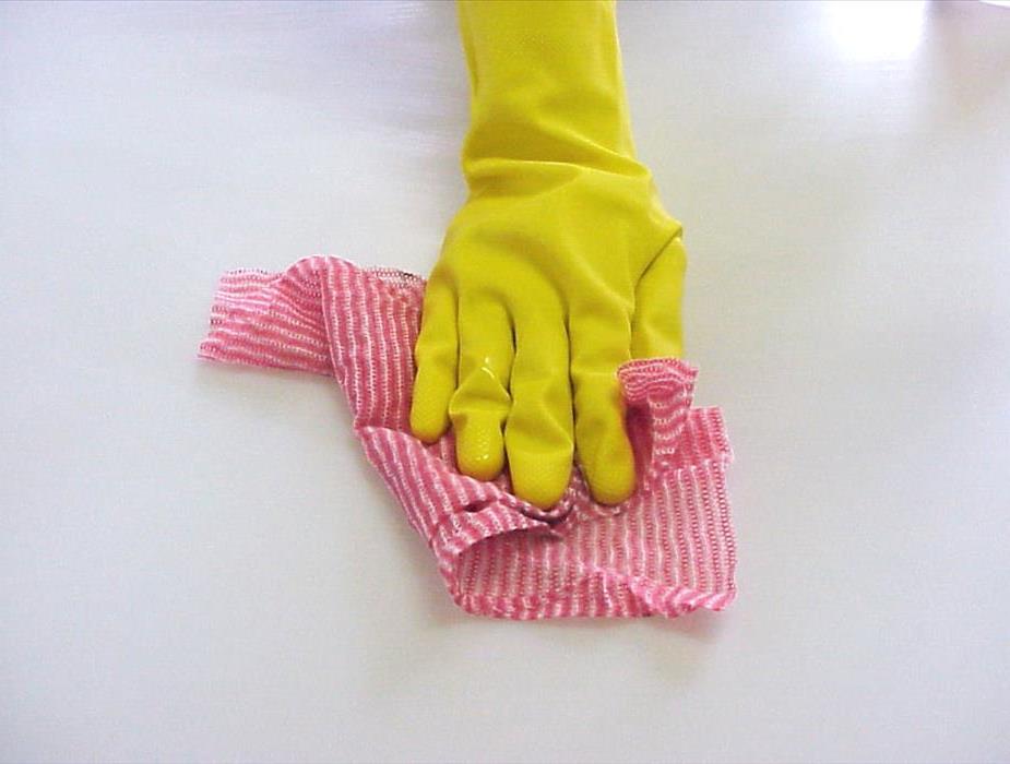 gloved hand cleaning surface